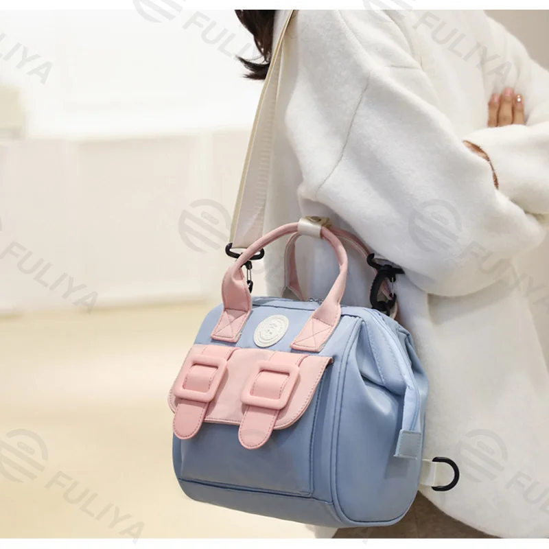 Guangzhou Fuliya Industry Co.,Ltd C-81130 Compact mommy bag, water-resistant, large capacity, foil-insulated bag, front pocket, inner zipper pocket, detachable hook, and long strap - hand, crossbody, or backpack carry for baby outings and pumping.