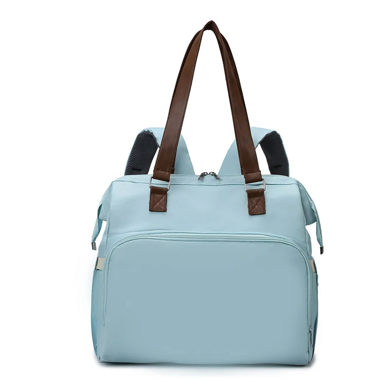 Guangzhou Fuliya Industry Co.,Ltd C-81133 Multi-functional mommy bag, water-resistant, large capacity, foil-insulated bag, wet/dry pocket, and hidden straps - hand or backpack carry with luggage strap for baby outings and travel.