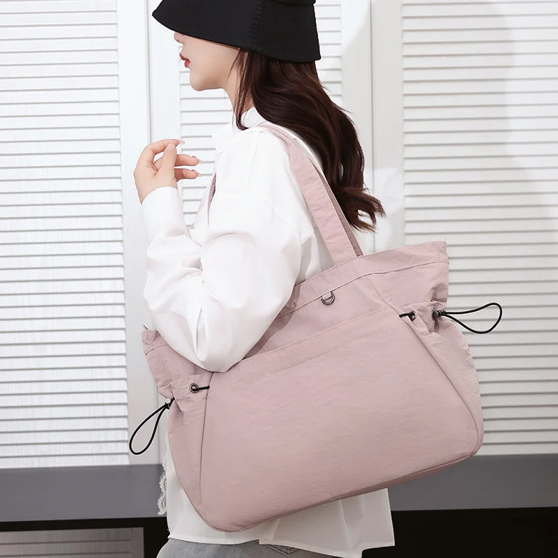 Guangzhou Fuliya Industry Co.,Ltd C-81184 Lightweight waterproof tote bag, large capacity, fits A4, smooth zipper, front/side pockets, D-ring, comfortable handle, and elastic drawstrings - for gym, shopping, travel, and daily use.