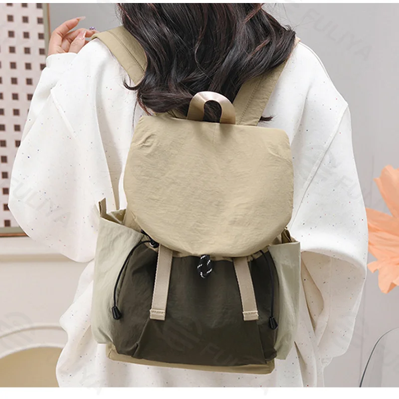 Guangzhou Fuliya Industry Co.,Ltd C-81240 Casual flap backpack, waterproof and lightweight, large capacity, magnetic front pocket, side pockets, and drawstring closure - for outdoor, hiking, and travel.