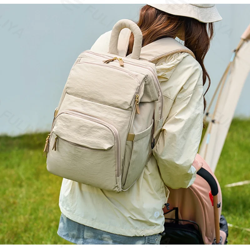 Guangzhou Fuliya Industry Co.,Ltd C-81299  Mommy backpack, water-resistant, large capacity, insulated bottle compartment, wide-opening main pocket, side tissue pocket, and comfortable handle - for baby outings.