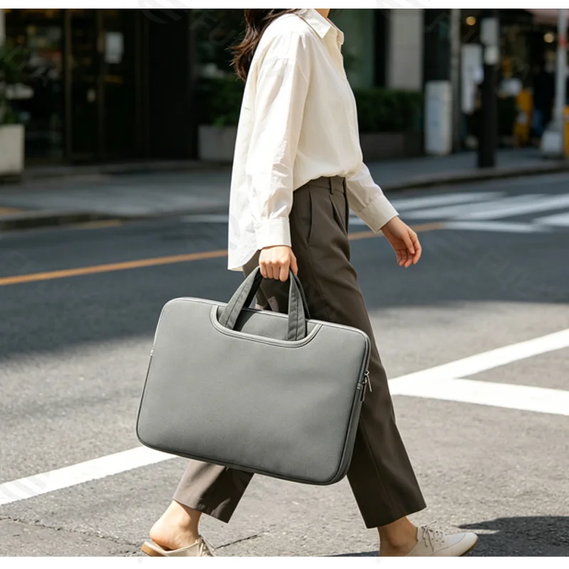 Guangzhou Fuliya Industry Co.,Ltd C-81384 This padded shockproof laptop handbag is made of durable waterproof fabric, large capacity for 14-inch laptops, plush lining for protection, with a hideaway handle and side pocket - ideal for commuting and travel.