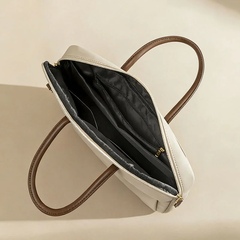 Guangzhou Fuliya Industry Co.,Ltd C-81386 This lightweight waterproof laptop bag features large inner pockets, back pockets, hidden front zipper pocket, and luggage strap - ideal for commuting and business.