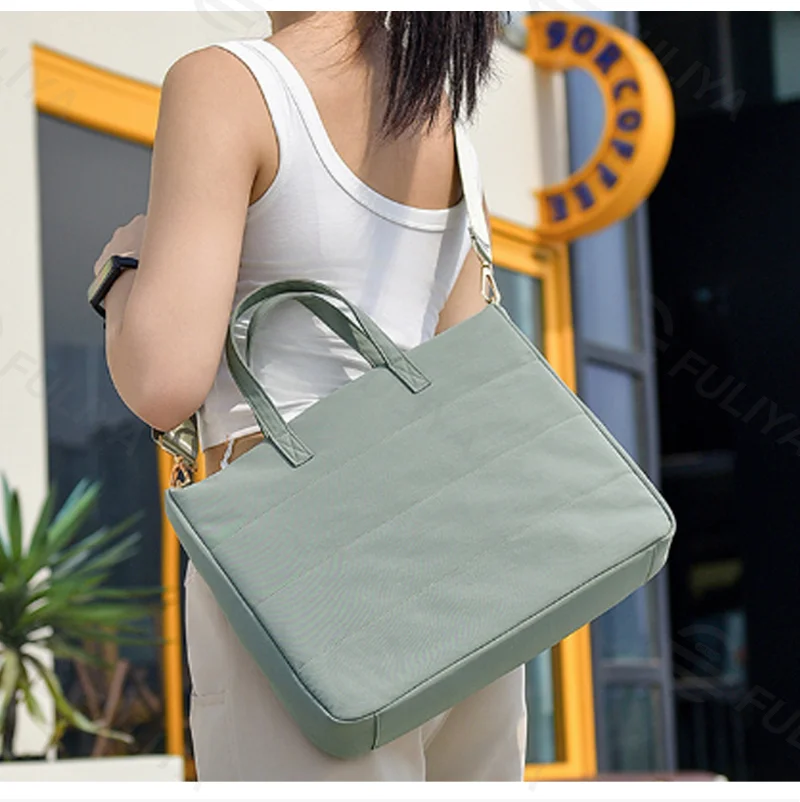 Guangzhou Fuliya Industry Co.,Ltd C-81401 This versatile tote bag is water-repellent and scratch-resistant, with air-cushion protection, large capacity for a laptop, detachable shoulder strap, and trolley strap - perfect for commuting and travel.
