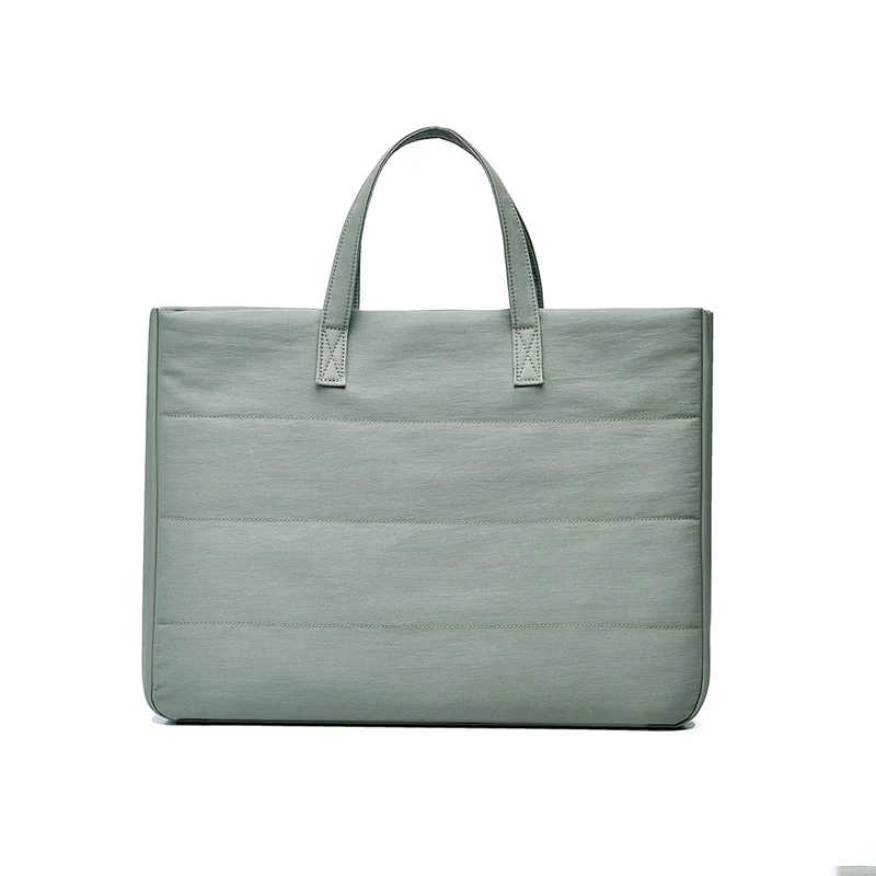 Guangzhou Fuliya Industry Co.,Ltd C-81401 This versatile tote bag is water-repellent and scratch-resistant, with air-cushion protection, large capacity for a laptop, detachable shoulder strap, and trolley strap - perfect for commuting and travel.
