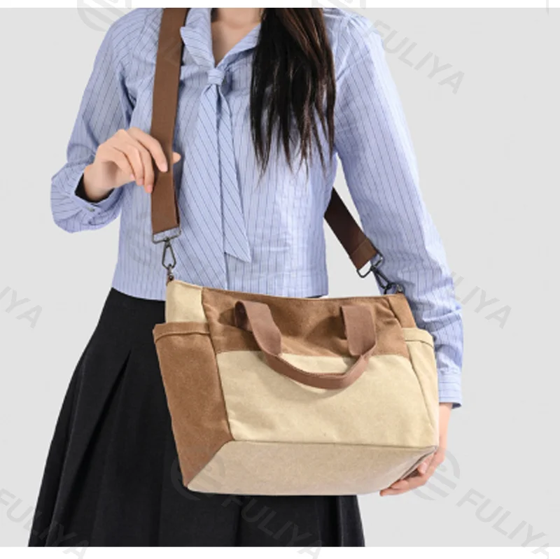 Guangzhou Fuliya Industry Co.,Ltd C-81447 This spliced canvas bag is lightweight and versatile, with hand/shoulder/crossbody carry, multi‑layer pockets, adjustable strap, and side pocket – for commuting and campus.