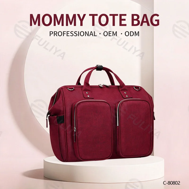 Guangzhou Fuliya Industry Co.,Ltd C-80802 Waterproof large-capacity diaper tote bag, supports hand/shoulder/crossbody carry. Features stroller hooks, front pockets, and a changing pad. For baby daily travel.