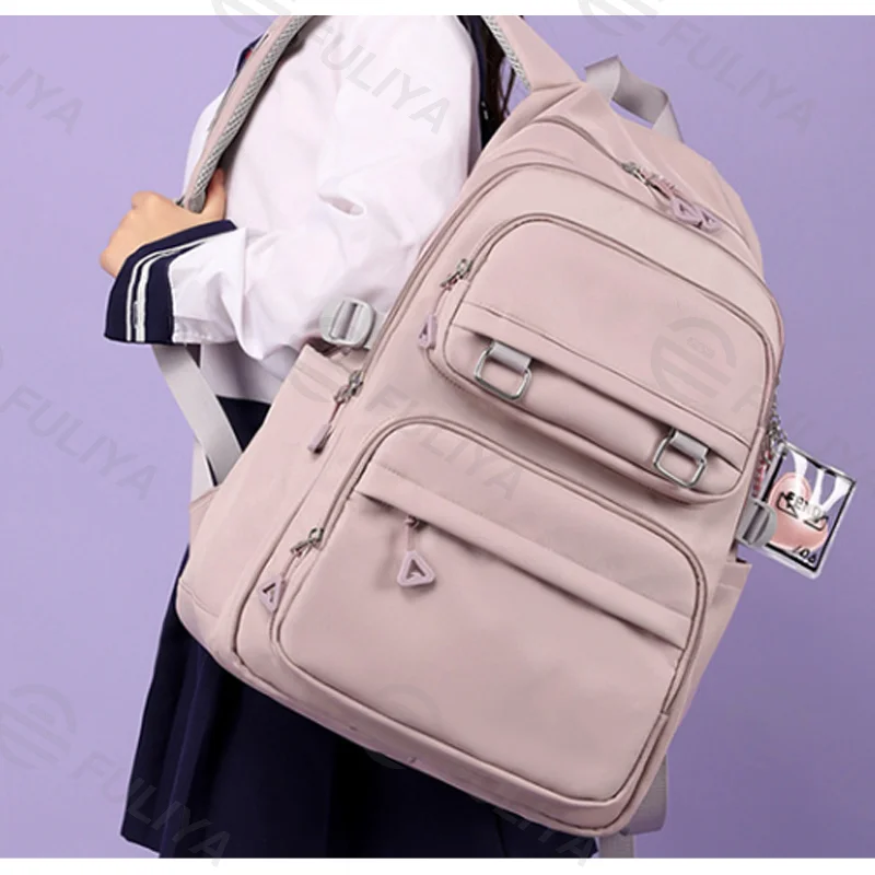 Guangzhou Fuliya Industry Co.,Ltd C-81050 Student load-reducing backpack, lightweight nylon, large capacity, front/side pockets, adjustable strap, spine-protecting back pad, and luggage strap - for primary and middle school students.